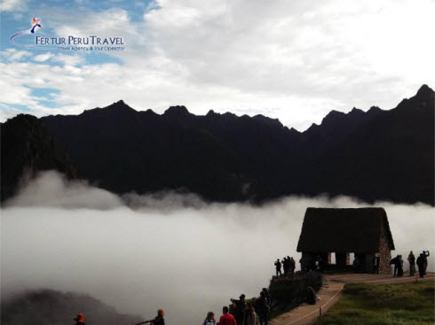 Fast moving shroud of fog wafts through Machu Picchu ruins