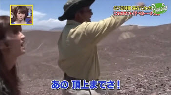 Archaeologist Mario Olaechea leads Japanese TV crew on foot to the restricted landscape of the Nasca Lines