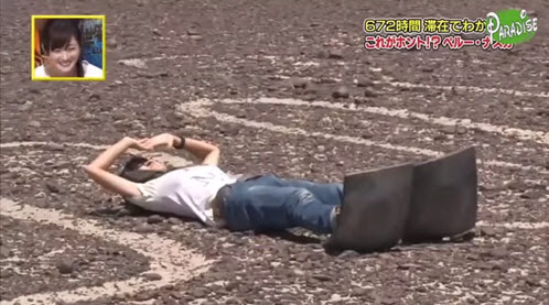 Reporter for a Japanese variety show laid on her back between the toes of  the iconic Nazca Hummingbird geoglyph