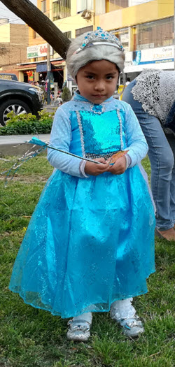 A little Peruvian girl dressed up as fairy princess prepares to go trick or treating for Halloween in Lima Peru