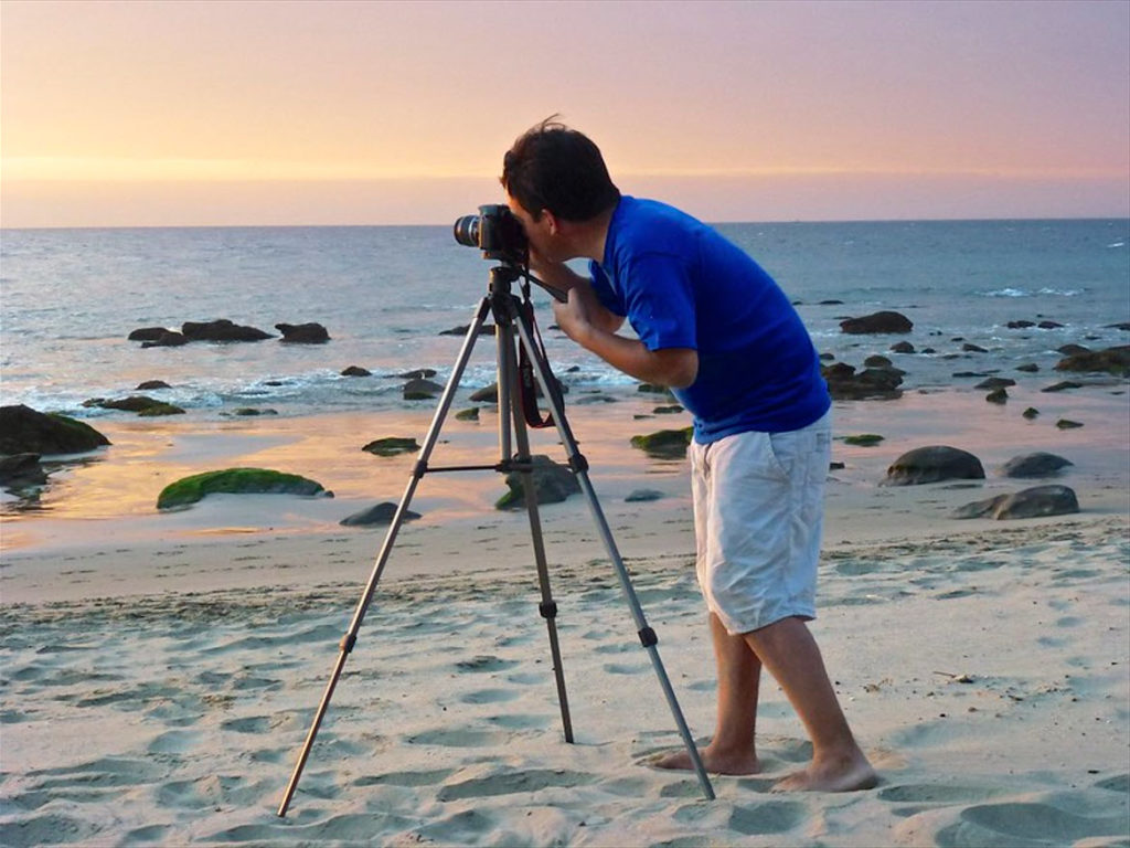 Man photographing the tranquil  at Las Pocitas beach. 