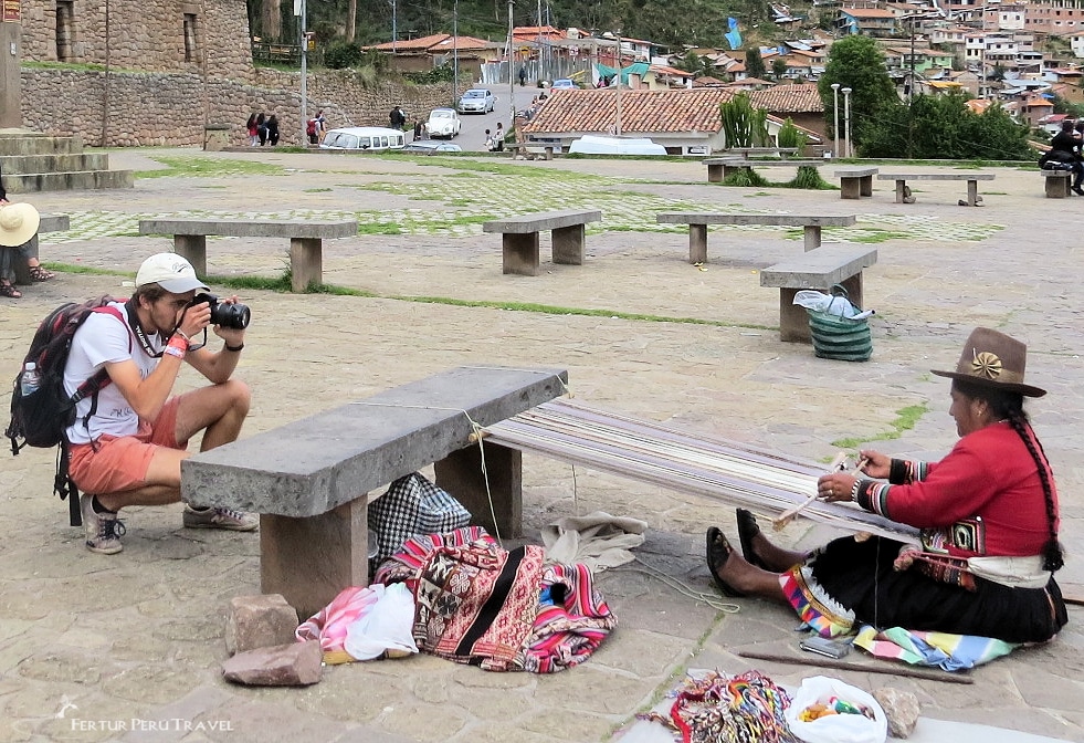 Tourist taking a photo of a woman weaving in Cusco. (He appropriately asked her permission before taking her picture.)