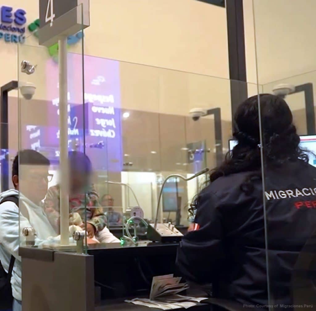Tourist passing through immigration with his child at Jorge Chavez International airport. 