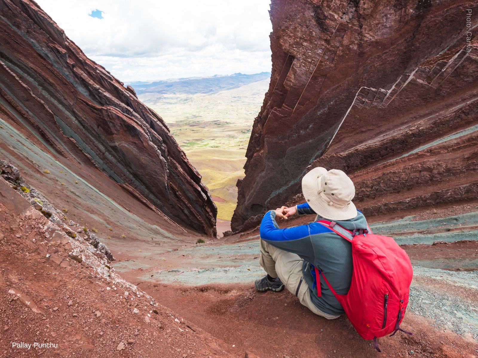 Trekker rests at the summit of Pallay Punchu Rainbow Mountain - Cusco, Peru