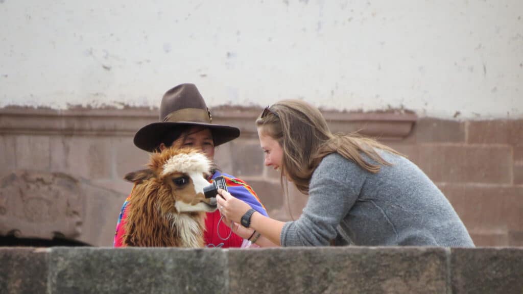 Independent woman traveler taking photos in Cusco, Peru