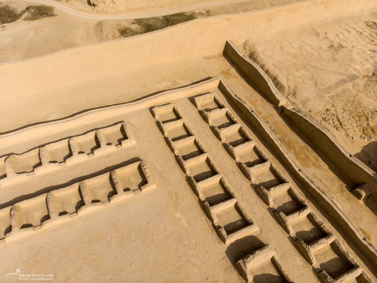 Chan Chan Aerial View | Chimú Adobe Storerooms and Compound Walls | Trujillo Peru | Peru Travel Blog Aerial drone view of Chan Chan looking down on rows of rectangular adobe storerooms and ceremonial structures within one of the royal compounds, with the massive perimeter walls and surrounding coastal desert visible, Trujillo, La Libertad, Peru. Photo: Fertur Peru Travel / Federico Matías Barreña.