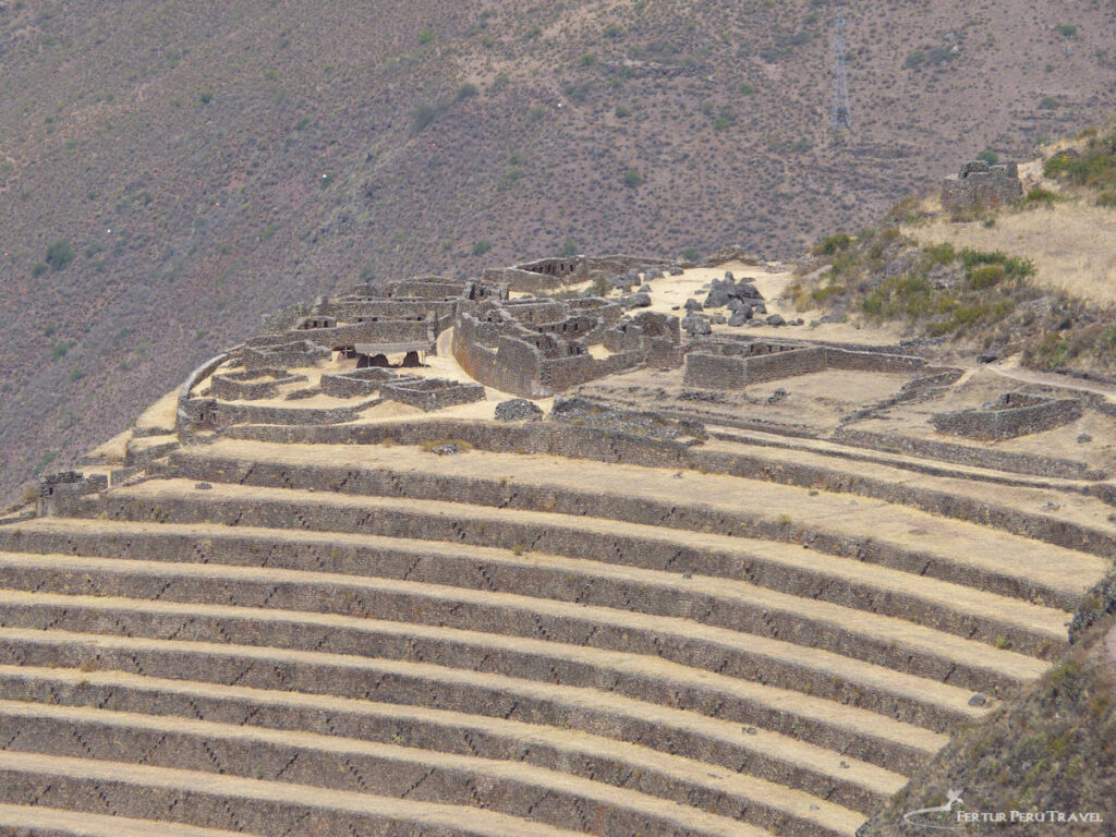 The Pisaqa Sector and Grand Terraces of Pisac | Peru Travel Blog Pisaq Ruins view showcasing the Pisaqa sector, an elite residential area of the Pisac Archaeological Park in Peru’s Sacred Valley. Perched atop a massive amphitheater of Incan agricultural terraces, the site features refined stone masonry and ceremonial baths, suggesting it was once home to Incan nobility. The surrounding "andenes" (terraces) demonstrate advanced Inca engineering, designed to maximize crop production and prevent soil erosion on the steep Andean mountainside.
