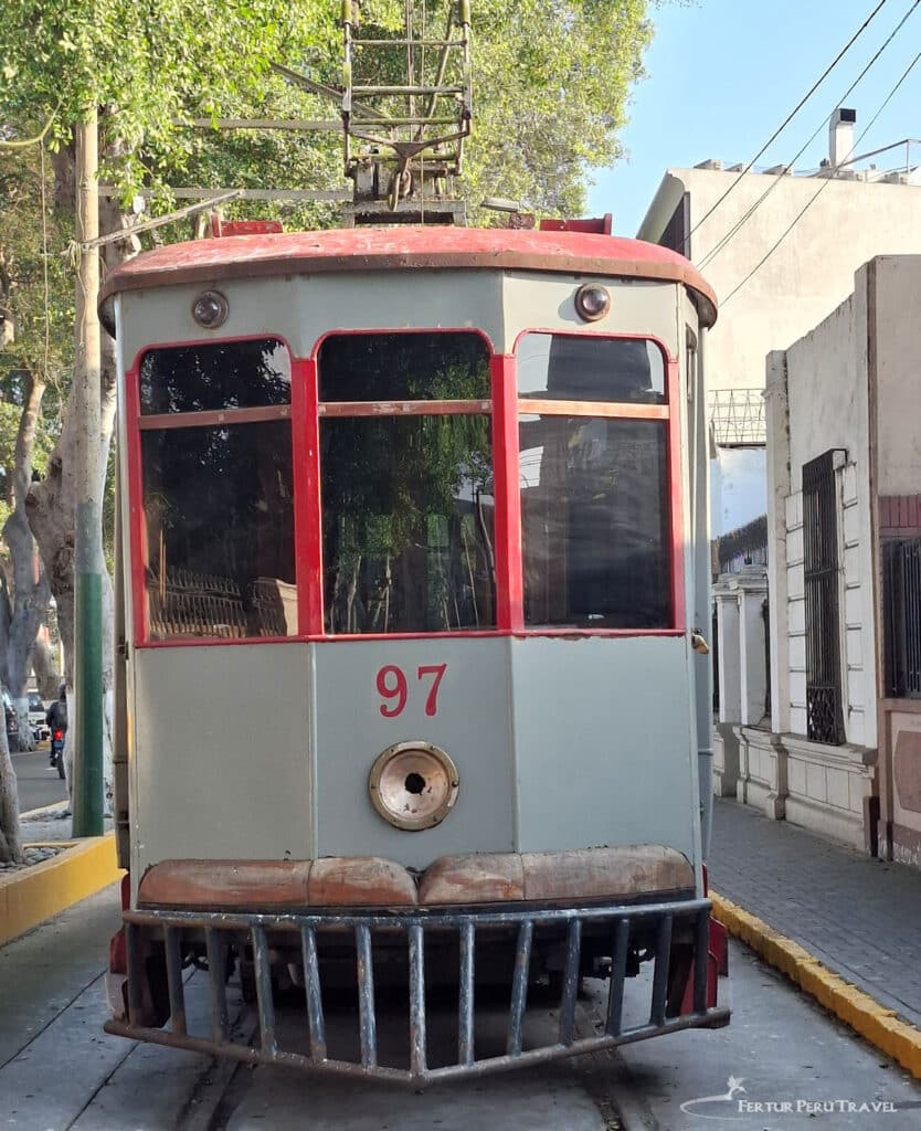 Historic Tram No. 97, Barranco | Lima, Peru | Peru Travel Blog Tram No. 97 — one of the surviving historic electric streetcars that once formed part of Lima's urban tramway network — sits on its embedded tracks on a quiet sun-dappled street in the Barranco district. Photo Fertur Peru Travel