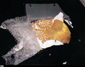 Stolen Moche Gold Backflap Recovered by FBI, Sipán Antiquities Case | Peru Travel Blog An FBI evidence photograph showing a large pre-Columbian Moche gold backflap and associated golden beads and ornaments loosely wrapped in bubble wrap inside an open suitcase, intercepted during an FBI sting operation in Philadelphia. Photo: FBI.