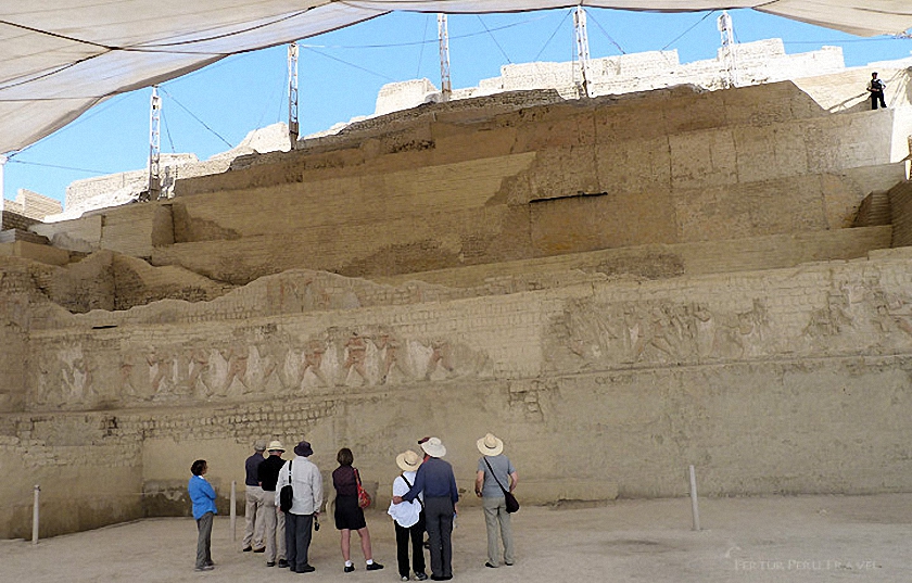 Fertur tour group at the Huaca Cao,  on Peru's Northern Coast. The ancient adobe wall depicts prisoners paraded in preparation for ritual sacrifice.