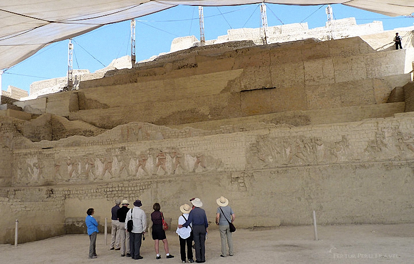 Fertur tour group at the Huaca Cao,  on Peru's Northern Coast. The ancient adobe wall depicts prisoners paraded in preparation for ritual sacrifice.  