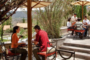 Guests enjoying themselves at outdoor tables in the hotel restaurant