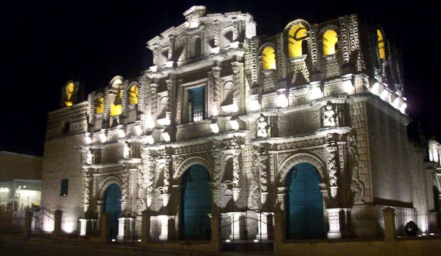 Santa Catalina Cathedral beautifully illuminated during a nighttime walking tour of Cajamarca.