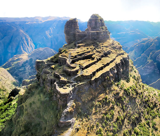 Waqrapukara, the Inca temple fortress built around two horn-shaped, towering mountain peaks.