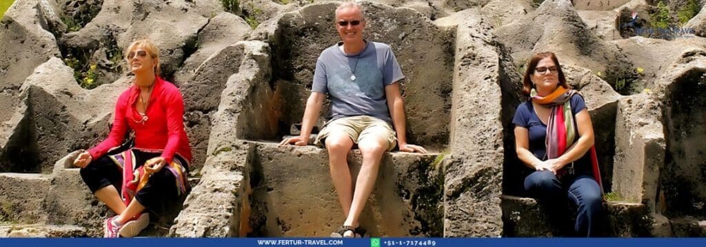 Fertur Peru Travel clients seated on the Inca stone thrones at the Temple of Lightning in Cusco