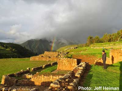 A Fertur client takes in the amazing view of a rainbow forming over the Chinchero ruins in Cusco