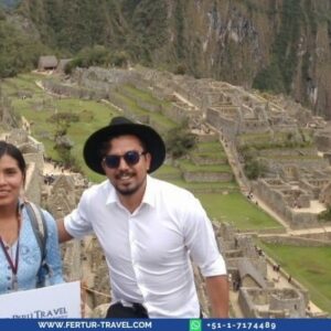 Fertur clients posing at Machu Picchu Inca citadel on a full-day private tour with Vistadome Train from Cusco