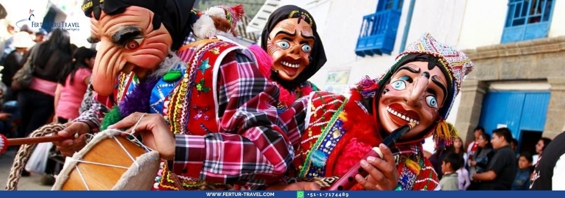 Traditional masked dancers at Paucartambo Festival wearing large character masks with exaggerated smiling faces and bright blue eyes, dressed in colorful plaid ponchos and traditional Andean textiles, performing in a street carnival setting