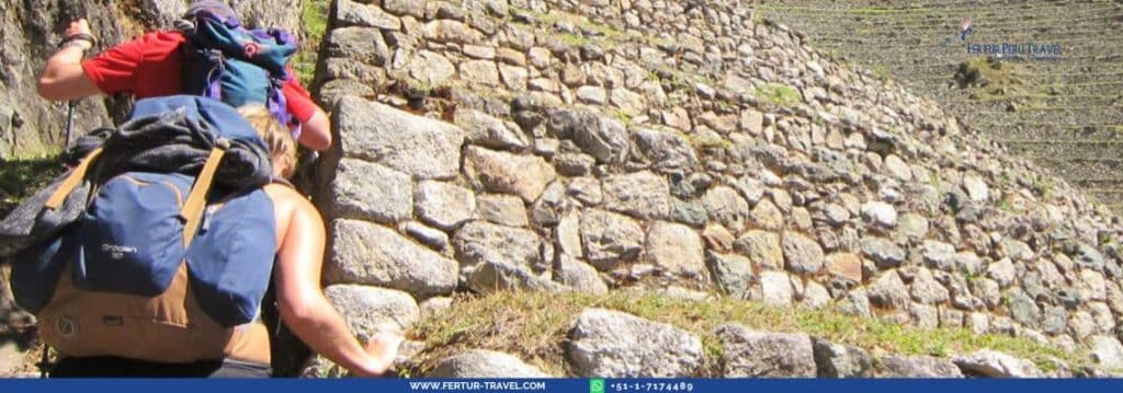 Hikers ascend the Inca Trail through the Winaywayna ruins to Machu Picchu