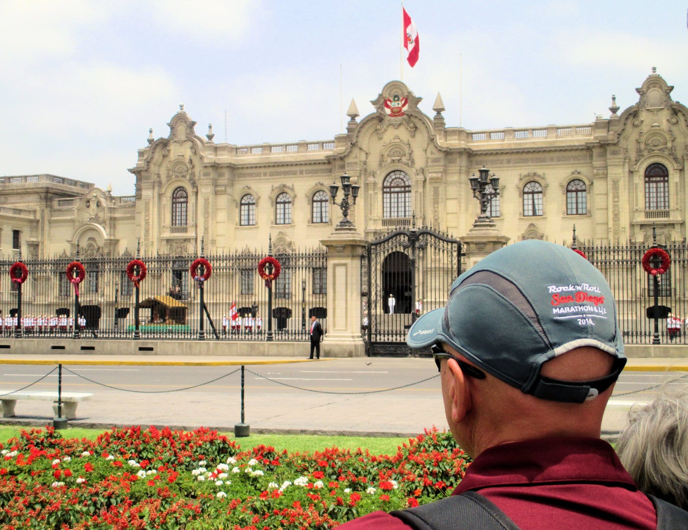 American tourist watches the noon changing of the guard at Peruvian Government Palace