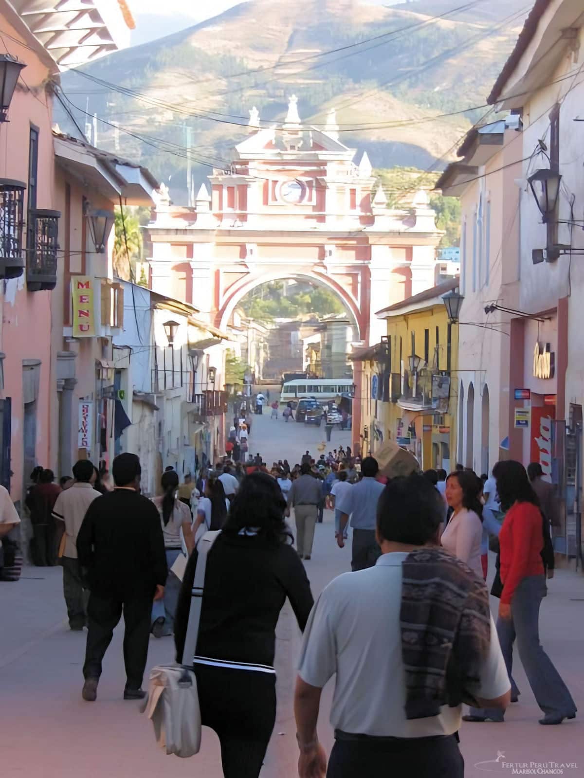 People walking on the pedestrian street from the Plaza de Armas toward the Triumphal Arch of Huamanga in Ayacucho - Peru
