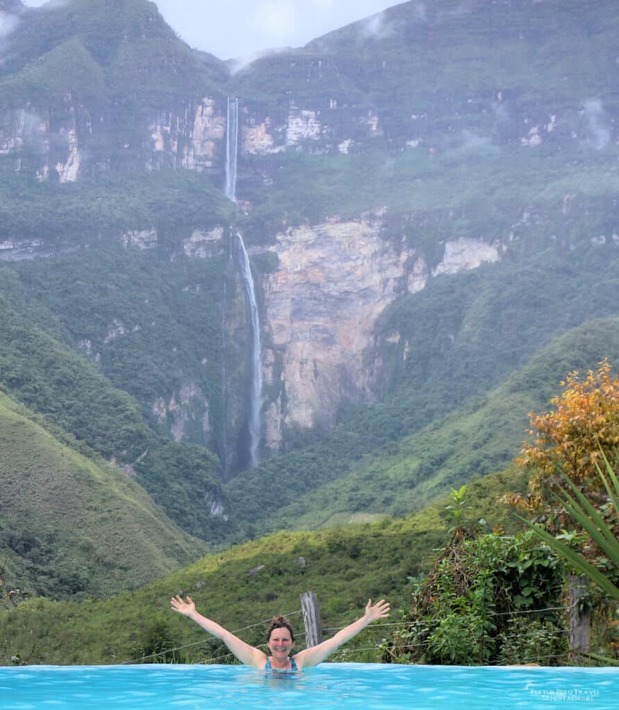 A traveler enjoys a natural pool in the lush cloud forest surroundings of the Gocta Waterfall area near Chachapoyas, Amazonas, Peru