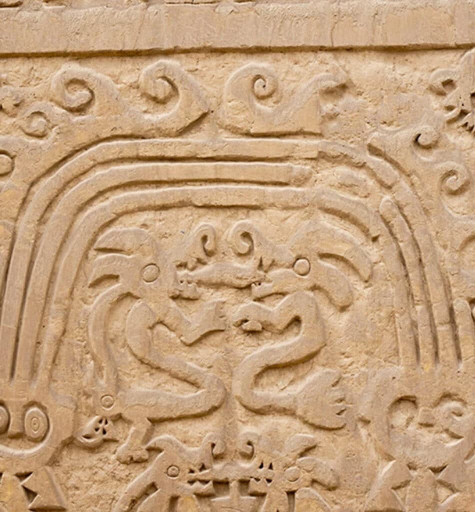Intricate adobe reliefs at Huaca del Dragón (also known as Huaca Arco Iris) near Trujillo, Peru, depicting a mythical serpent framed by concentric arches — a masterpiece of pre-Columbian Chimú craftsmanship.