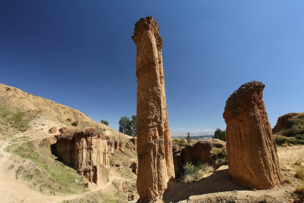 Towering sandstone columns rise against a deep blue Andean sky at Torre Torre, one of Huancayo's most dramatic natural landmarks, just 1.4 miles (2.3 km) from the city center.
