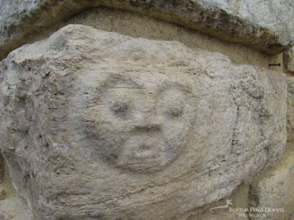 Close-up of a carved stone face on a cornerstone at Kuélap fortress, an example of Chachapoya stone carving art at the pre-Columbian ruins near Chachapoyas, Peru